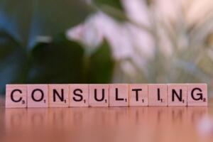 Peças de letras formando a palavra consultoria em inglês sobre mesa